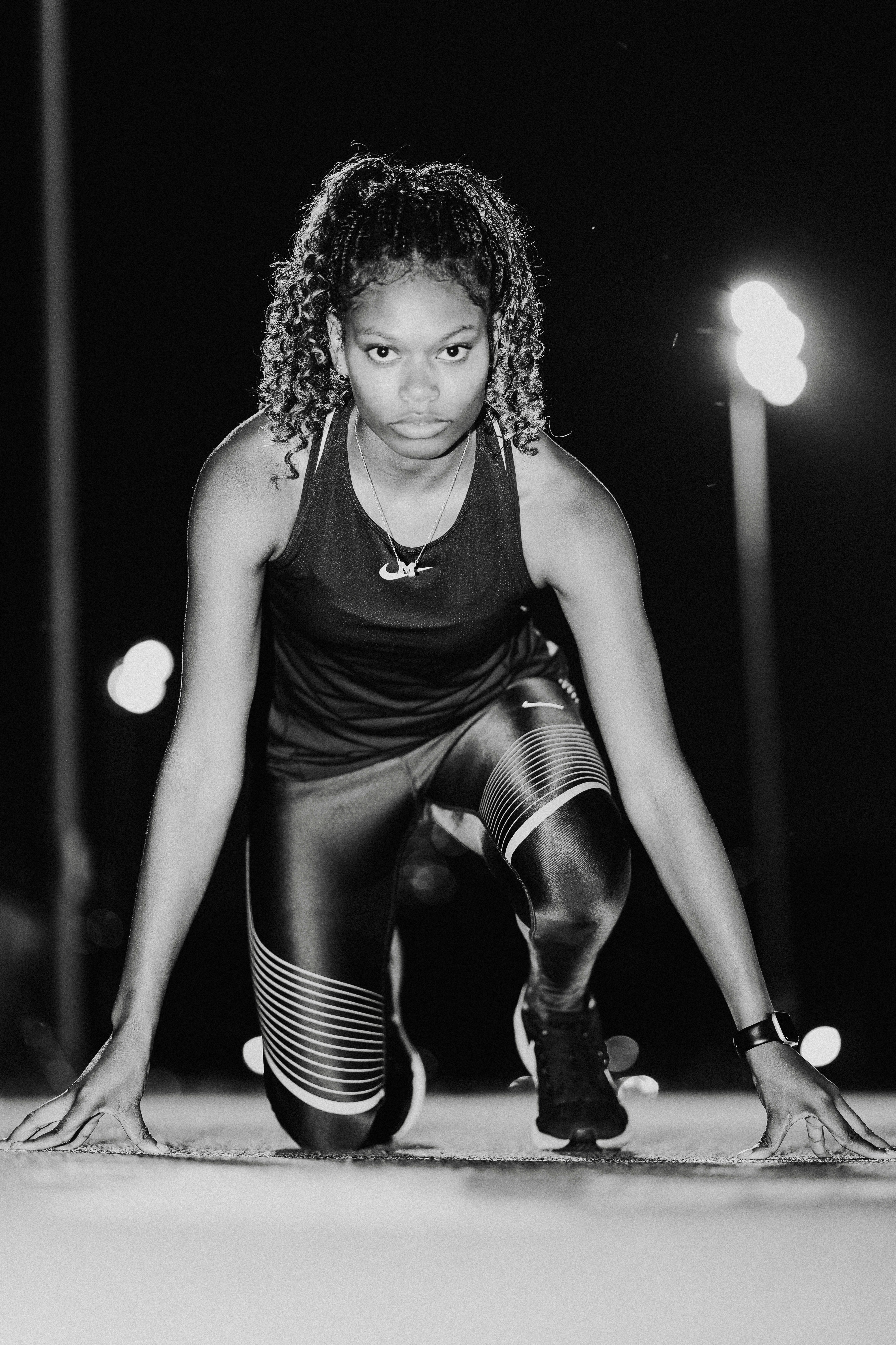 A black and white photo of a woman stretching