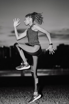 A woman jumping in the air in a field