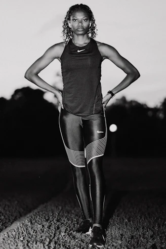 A black and white photo of a woman in tights