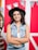 A woman with a hat is posing for a picture