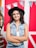 A woman with a hat is posing for a picture