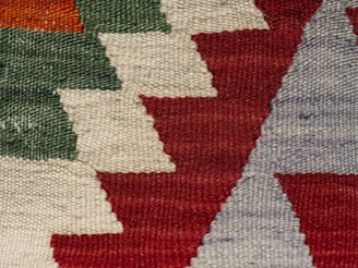 A close up of a rug with many different colors