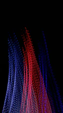 A bunch of red, white and blue beads on a black background