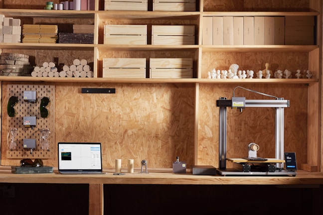 A desk with a laptop on it in a room