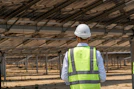 A man wearing a safety vest and hard hat