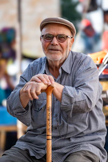 A man sitting on a bench holding a baseball bat
