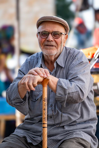 A man sitting on a bench holding a baseball bat