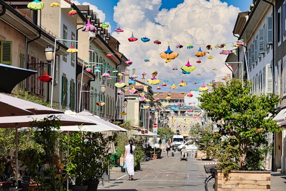 A group of people walking down a street under umbrellas