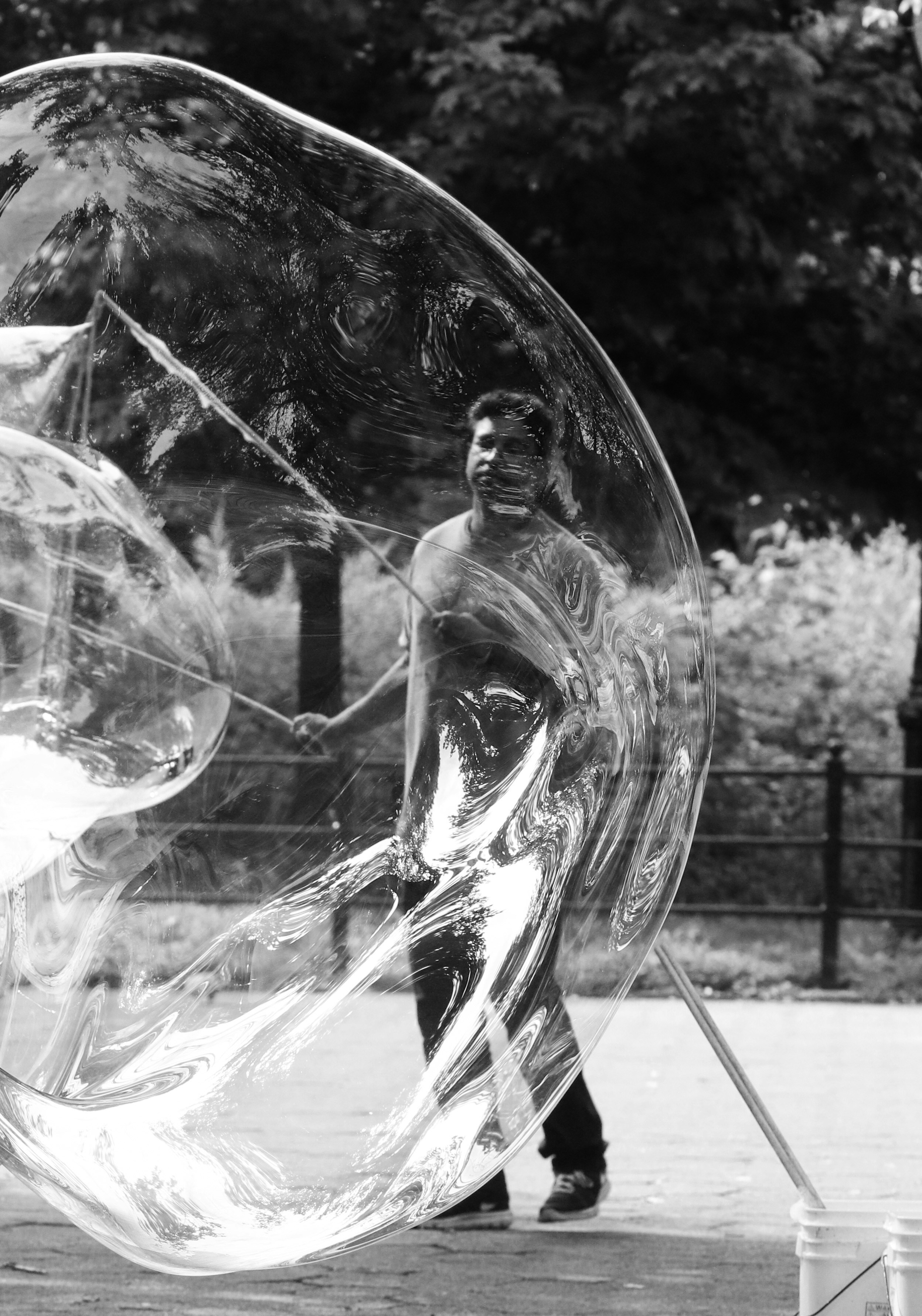 A man walking past a giant bubble ball
