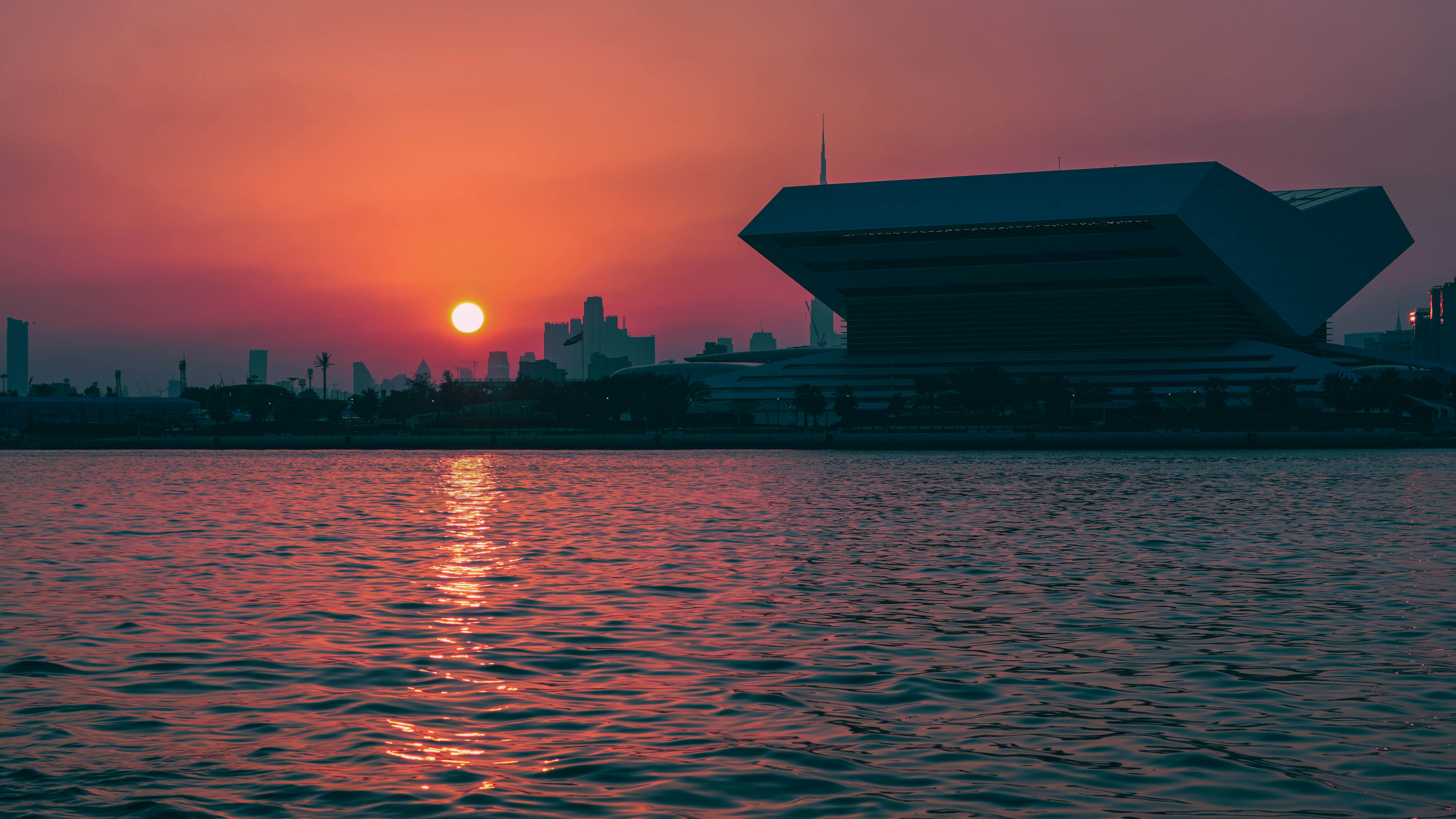A large body of water with a sunset in the background