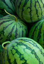 A pile of watermelon sitting next to each other