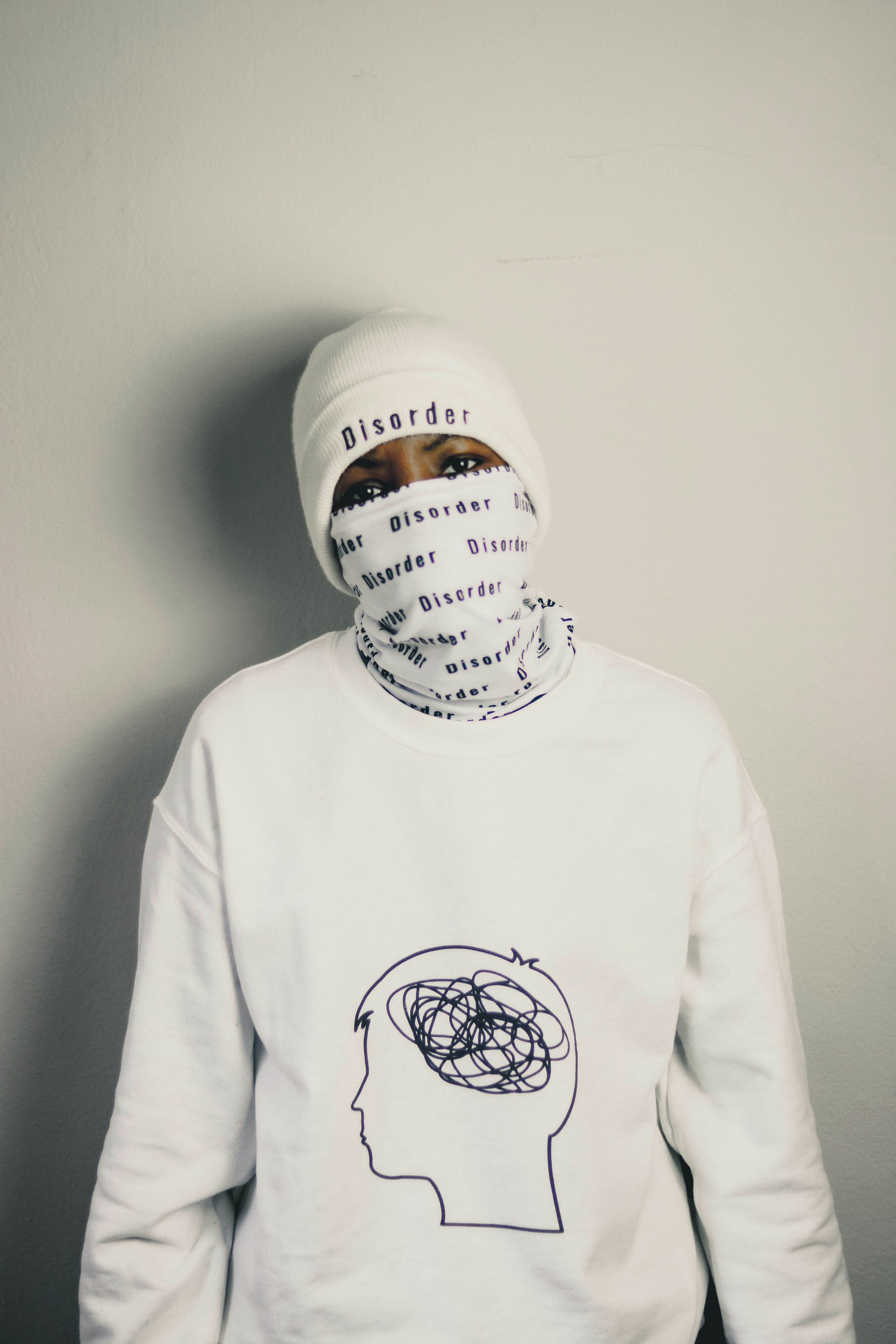 A person wearing a white hoodie with a graphic on it