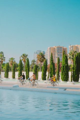 A group of people riding bikes on a beach