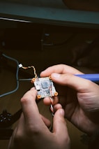 A person is working on a circuit board