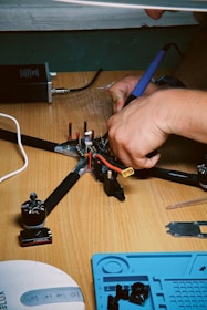A person working on a piece of equipment on a table