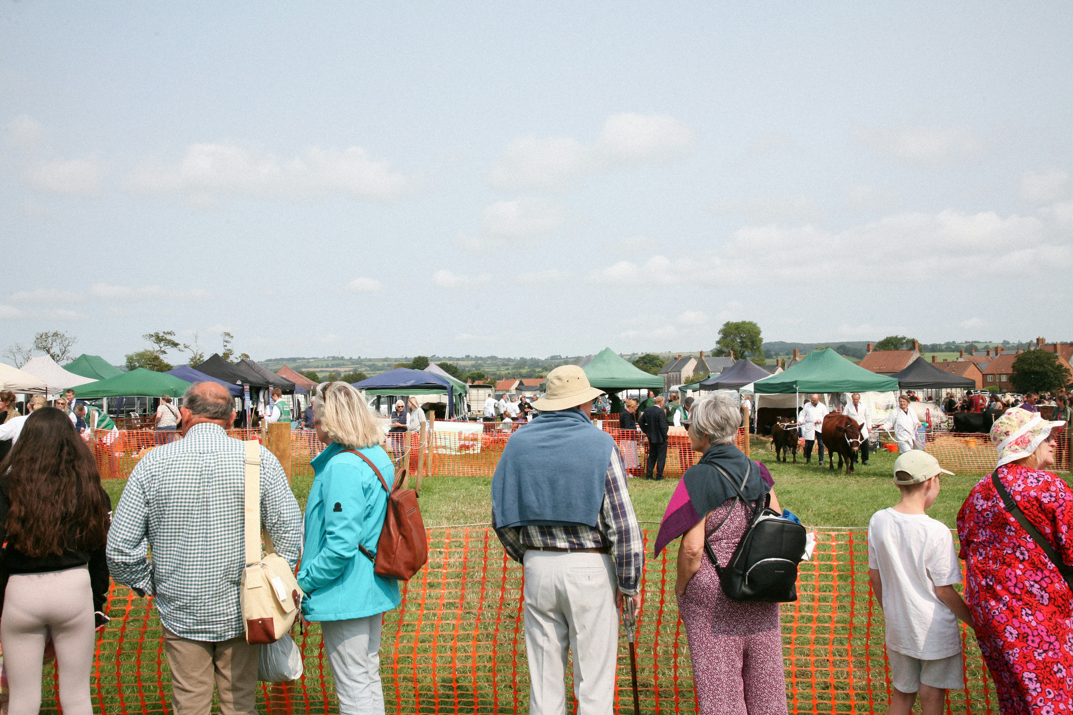 A group of people standing next to each other near a fence