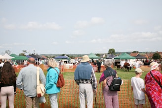 A group of people standing next to each other near a fence