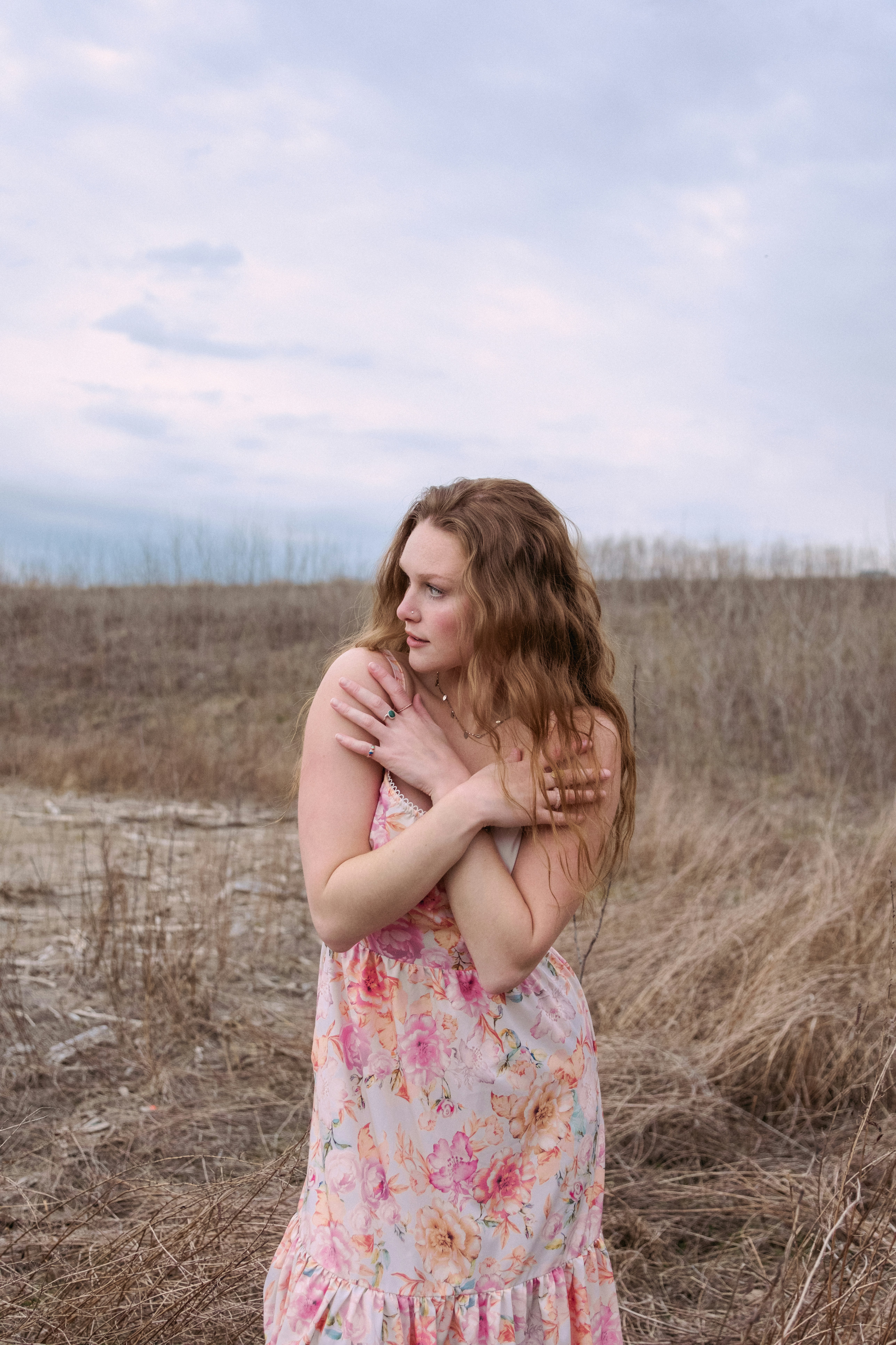 A woman in a dress standing in a field