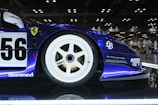 A blue race car on display in a showroom
