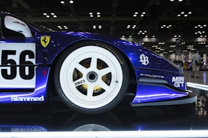 A blue race car on display in a showroom