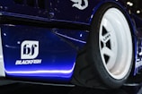 A close up of a blue race car on display