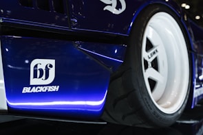 A close up of a blue race car on display
