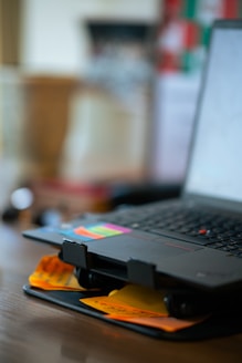 A laptop computer sitting on top of a wooden table