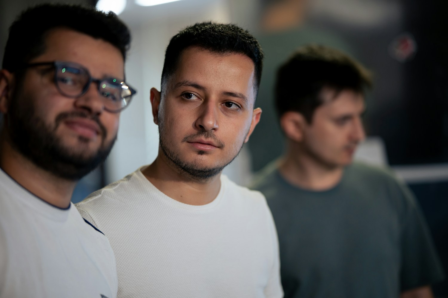 A thoughtful professional working on a laptop in a contemporary office space, emphasizing concentration and productivity.