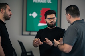 A group of men standing around each other in a room