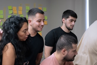 A group of people looking at a computer screen