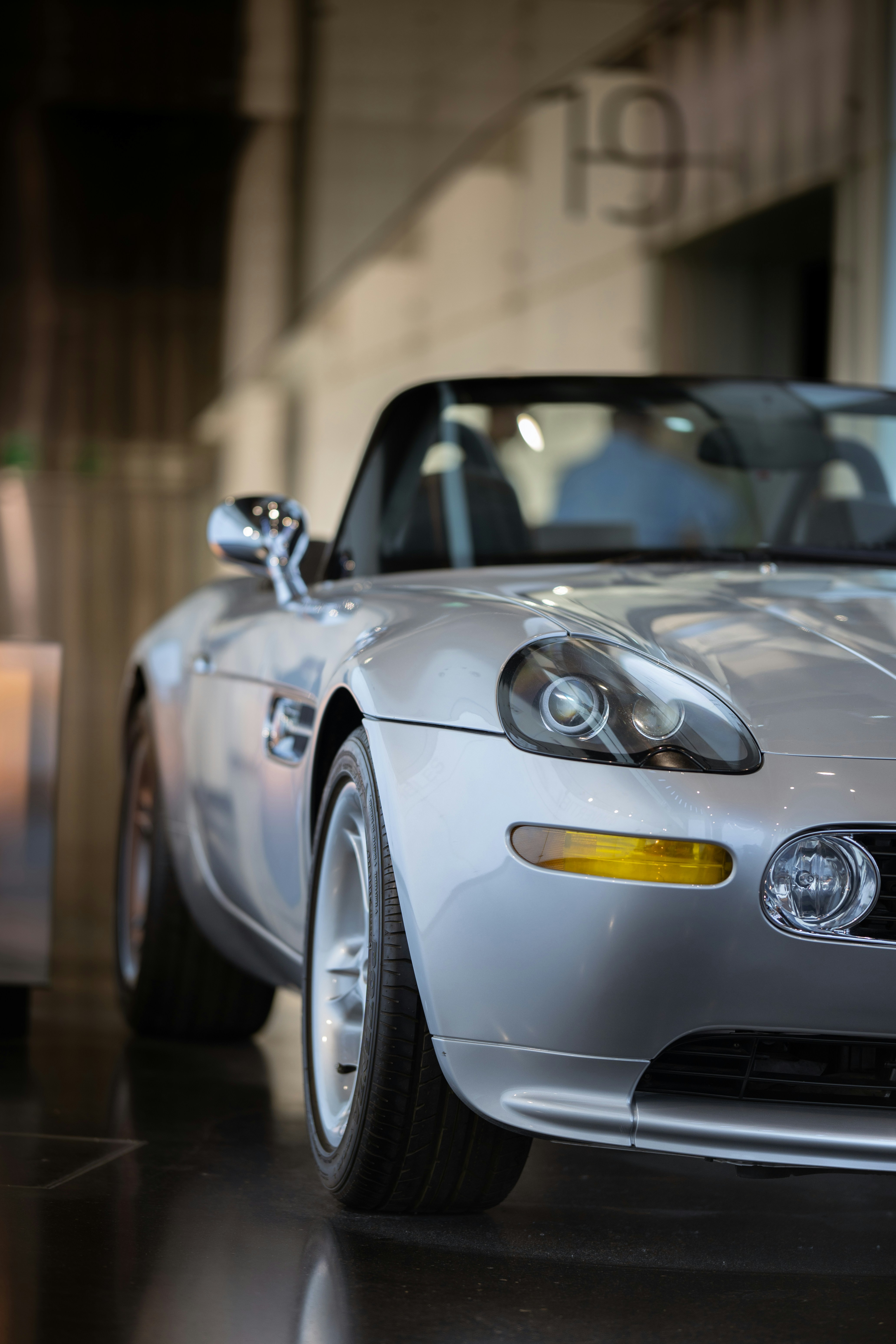 A silver sports car parked in a garage