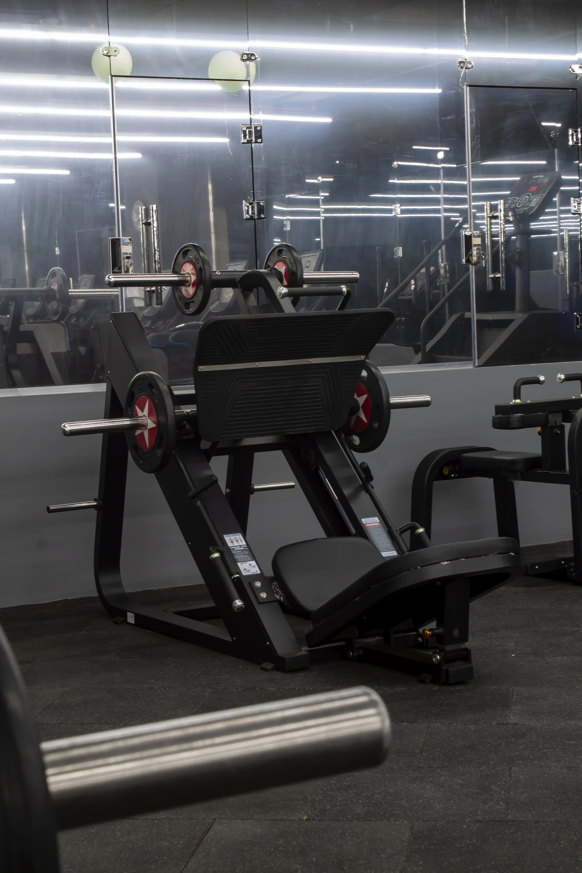 A gym filled with machines and weight plates