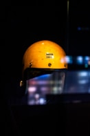 A yellow helmet sitting on top of a table