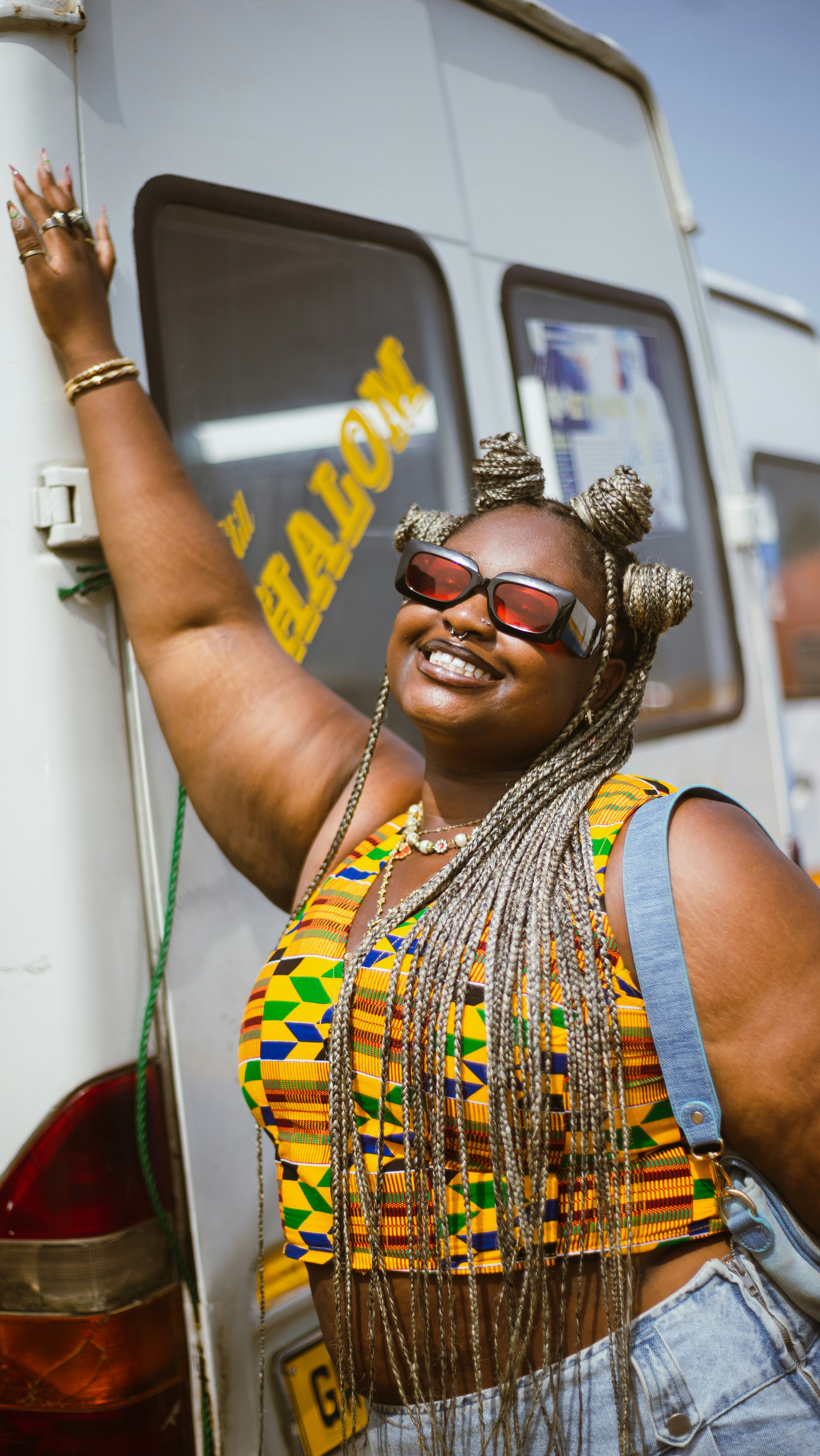A woman standing in front of a white bus