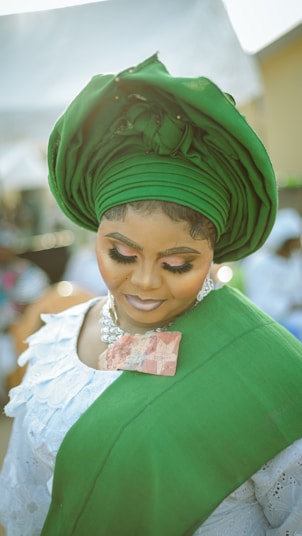 A woman in a green dress and a green hat