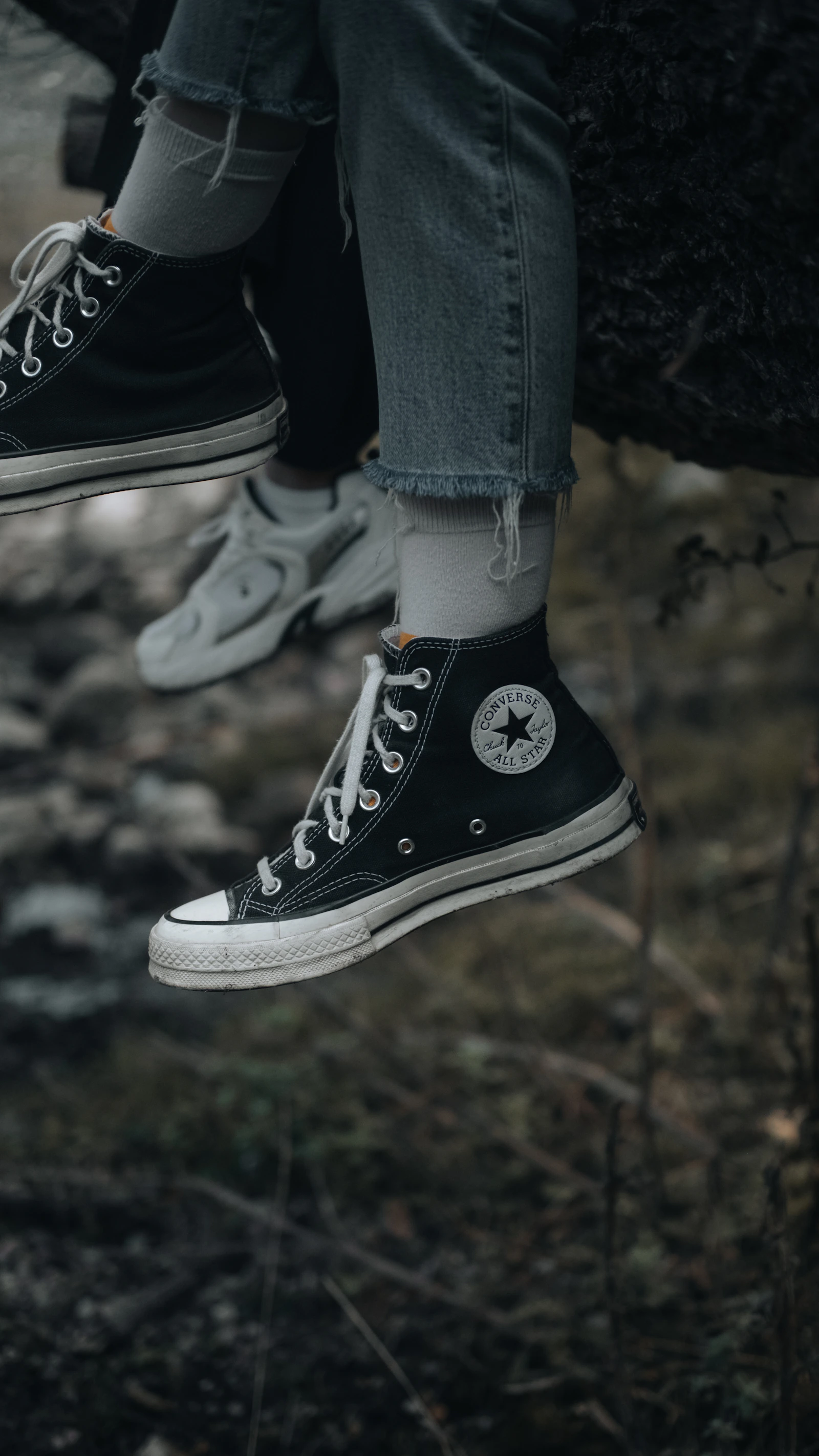 Black Converse high tops on feet