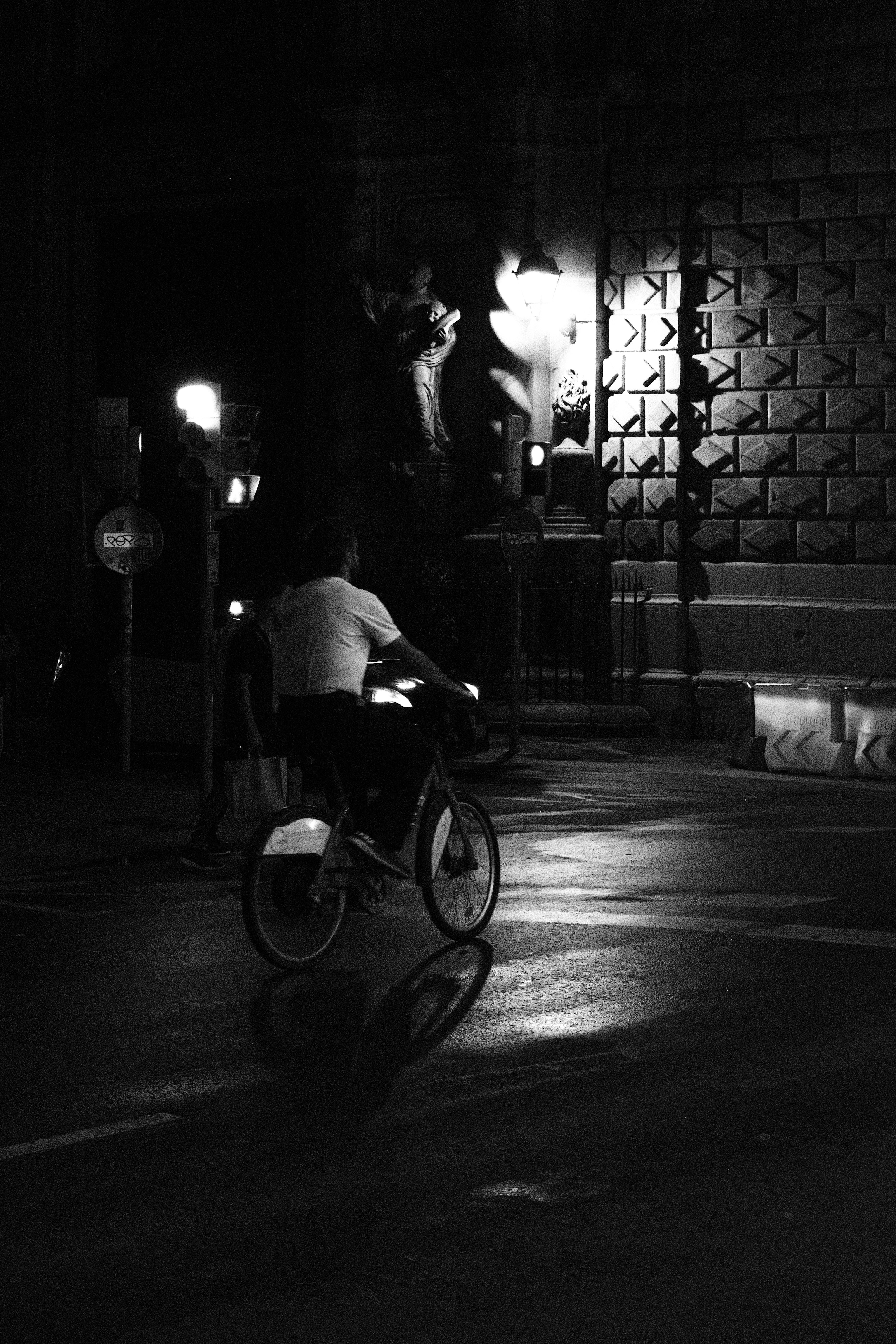 A man riding a bike down a street at night