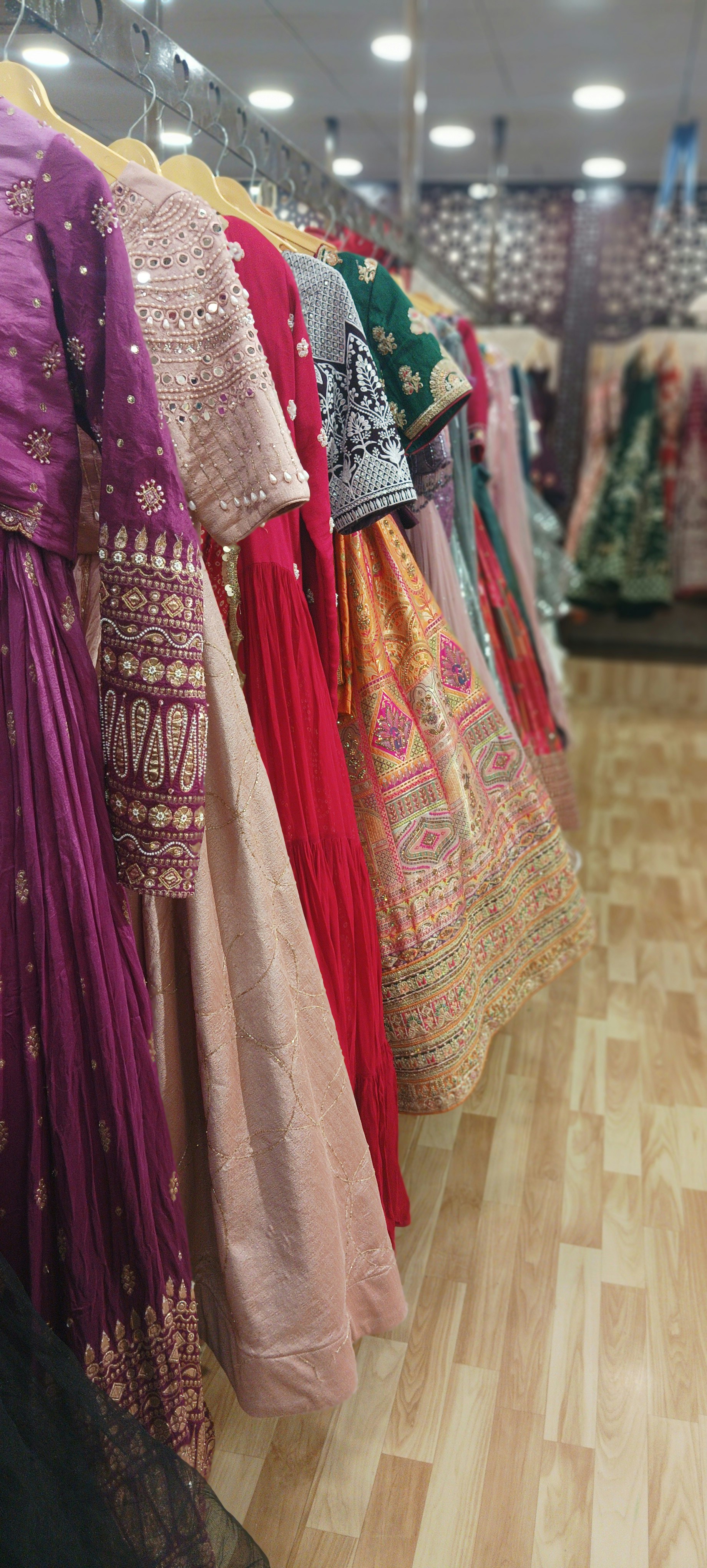 Colorful Indian fashion garments hanging in bright boutique