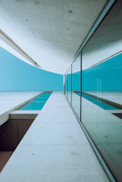 A long hallway with a view of a body of water