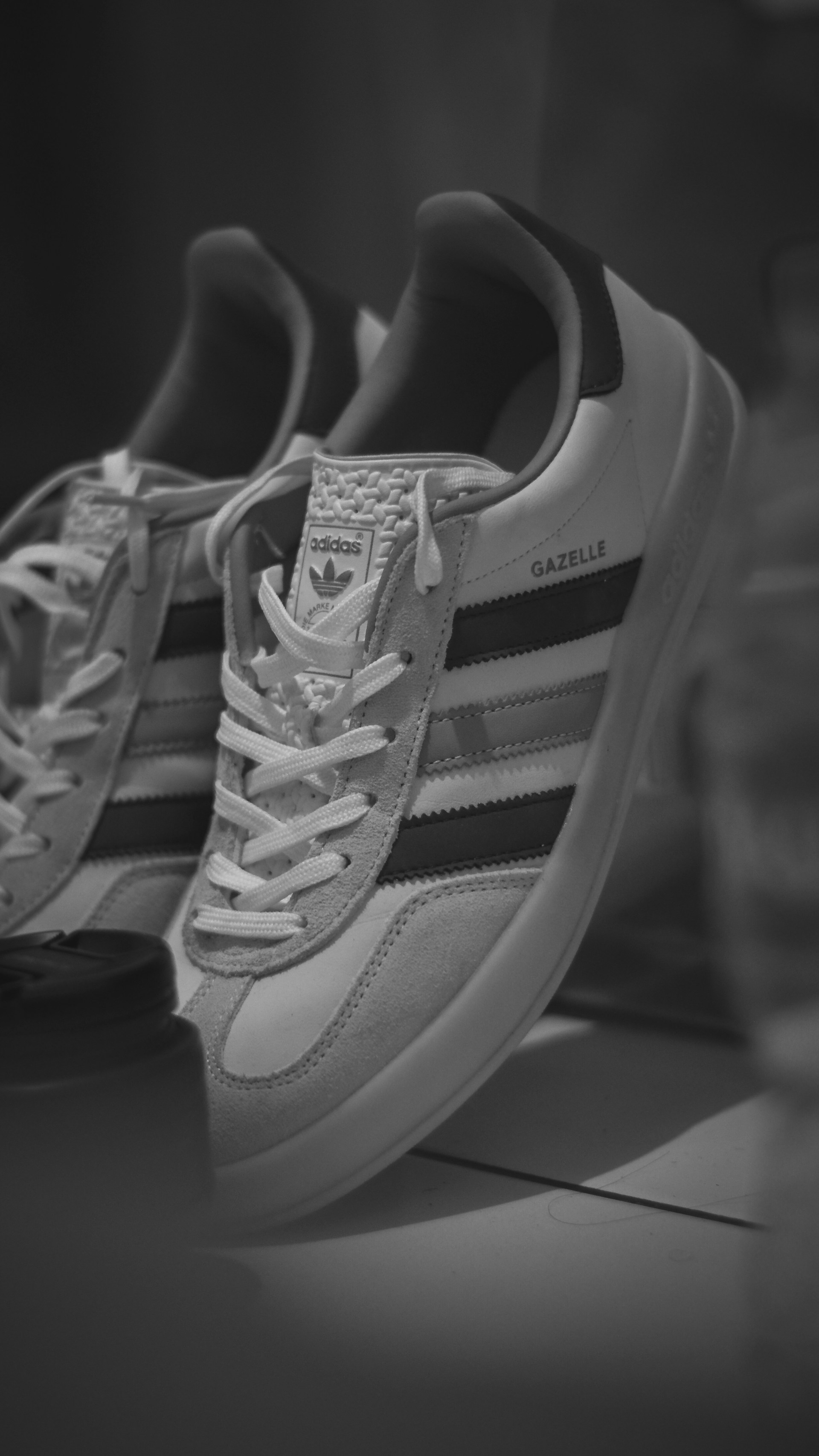 A pair of adidas sneakers sitting on top of a table