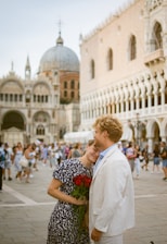 A man and a woman standing in front of a building