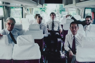 A group of men sitting on top of a bus