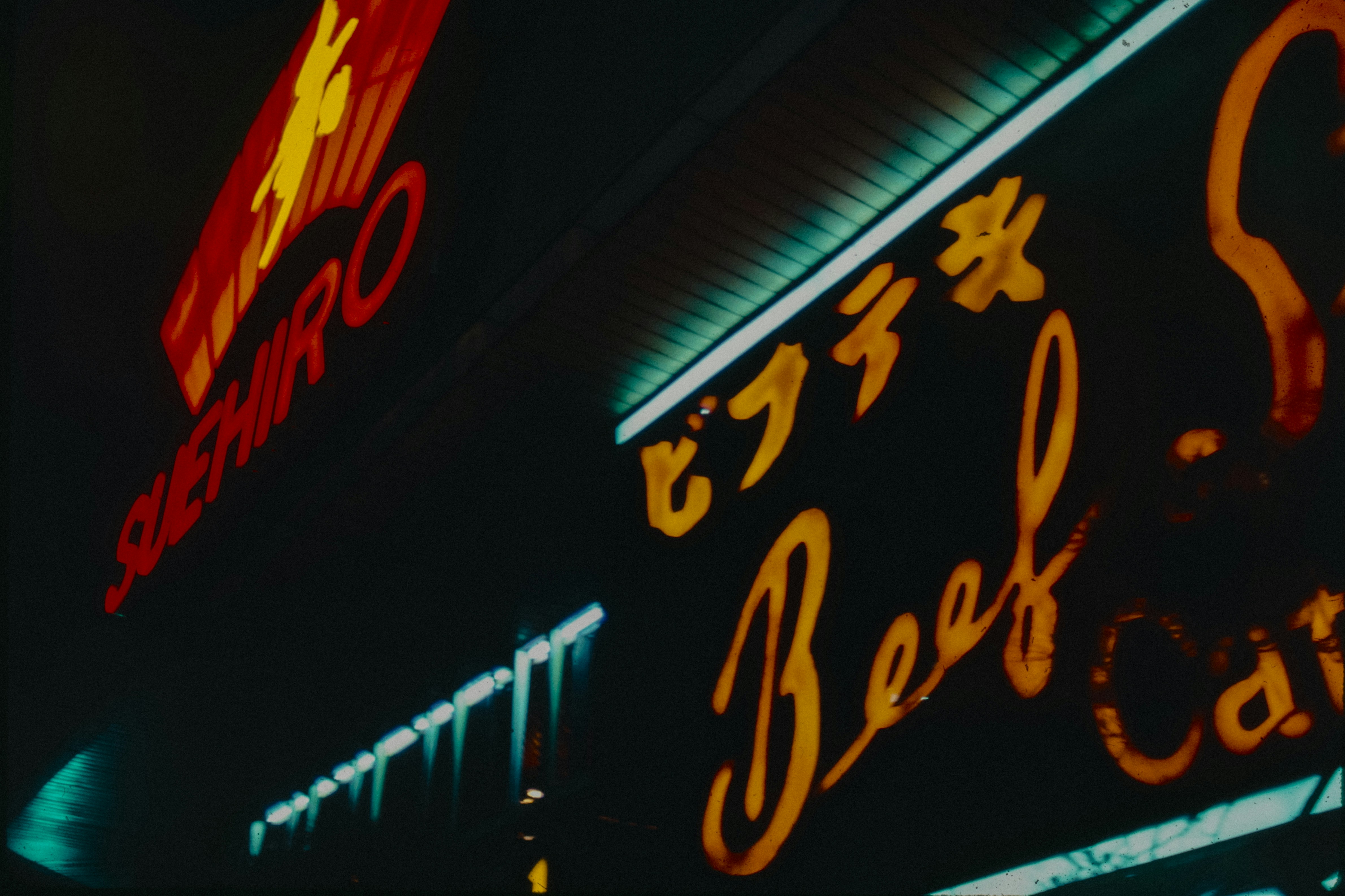 A neon sign is lit up at night