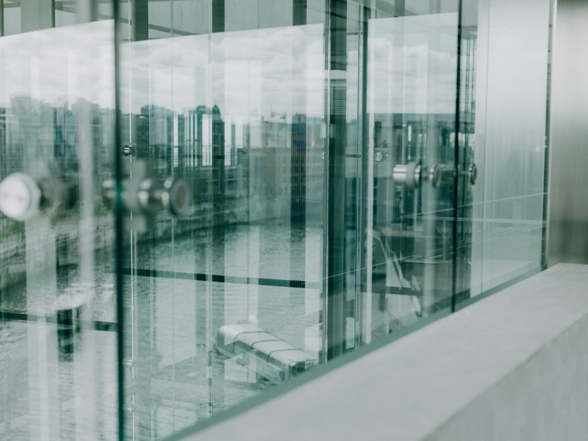 A man walking down a sidewalk next to a tall building