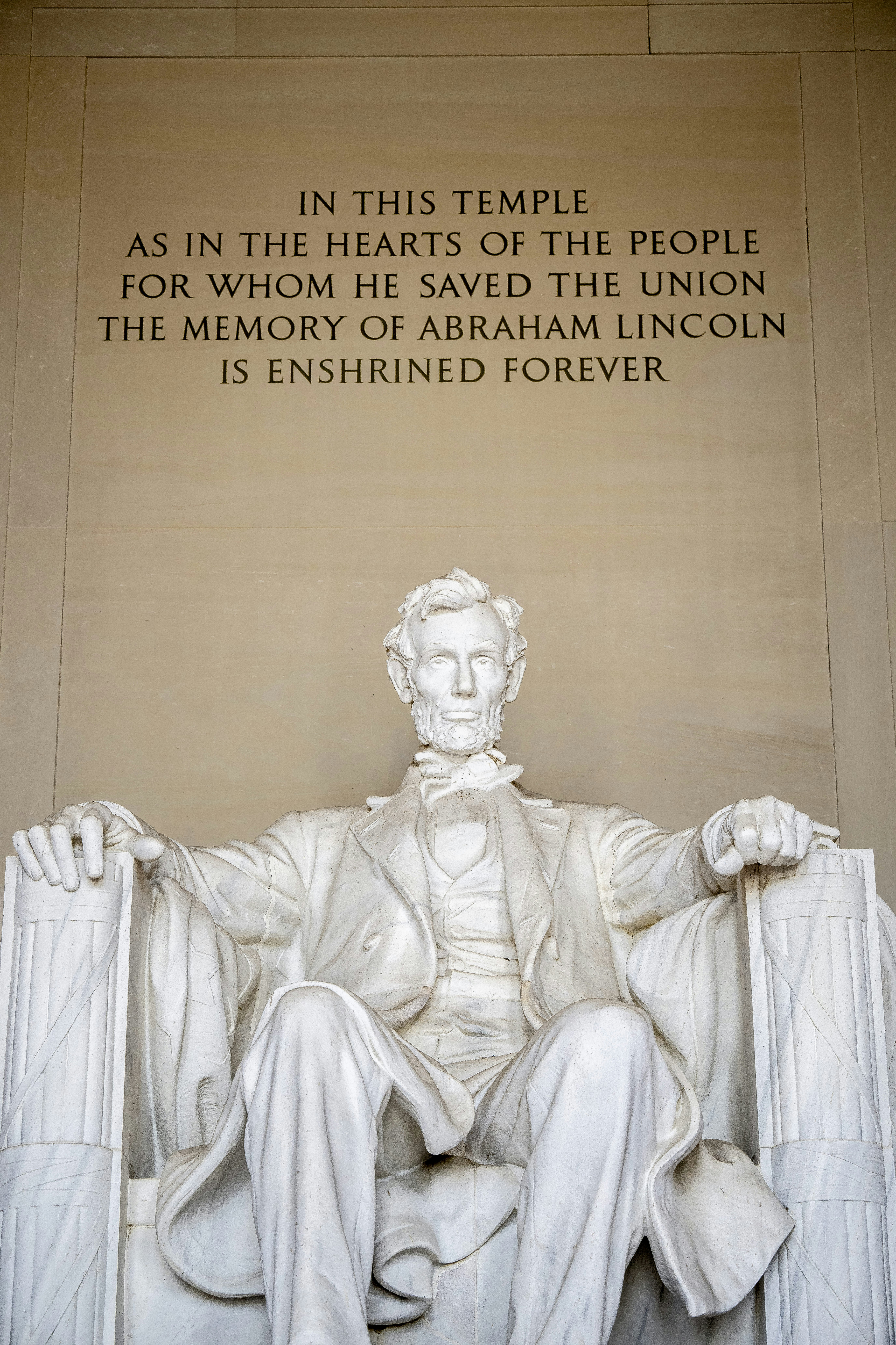 A statue of abraham lincoln in front of the lincoln memorial
