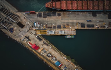 An aerial view of a cargo ship docked at a dock