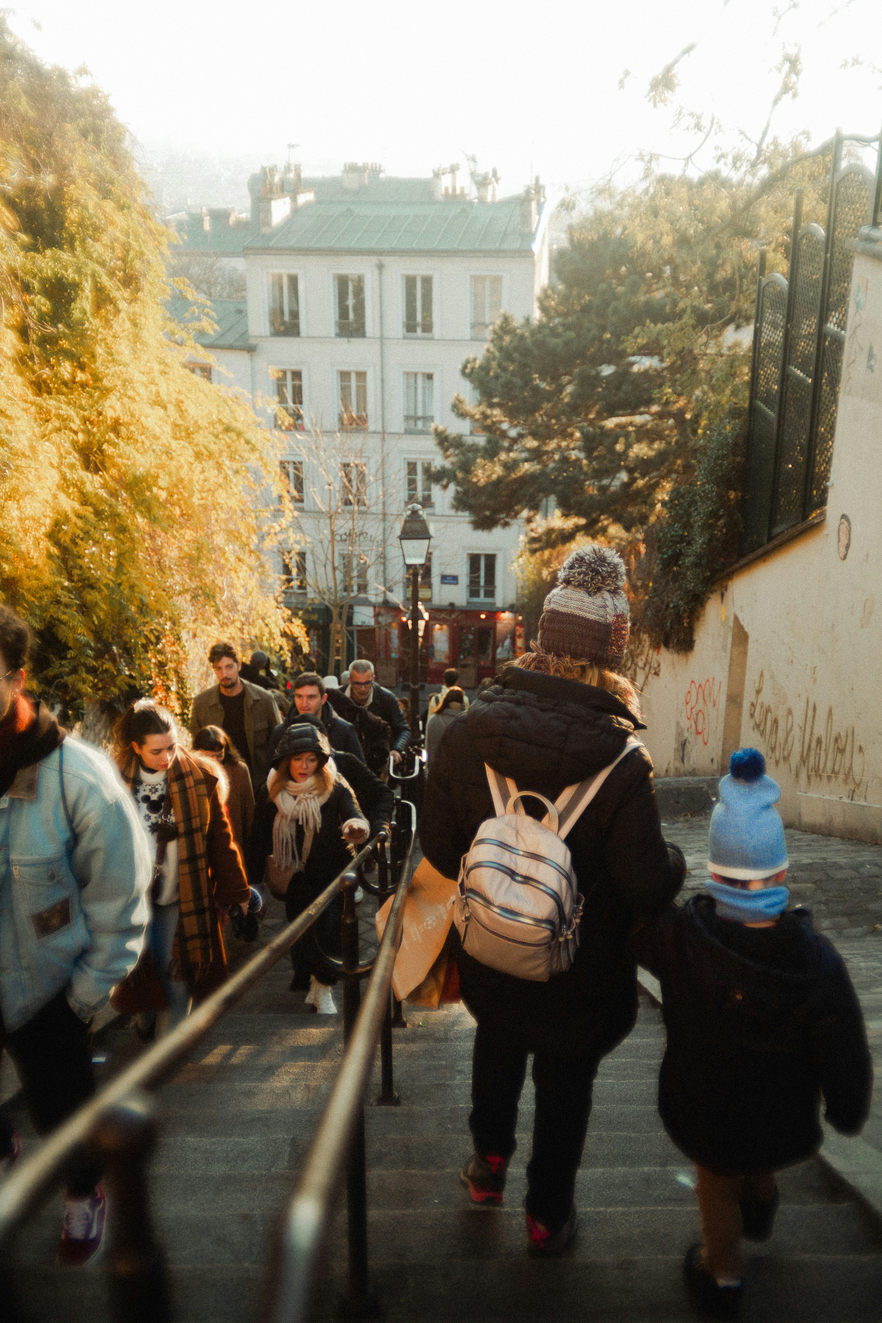 A group of people walking up a flight of stairs