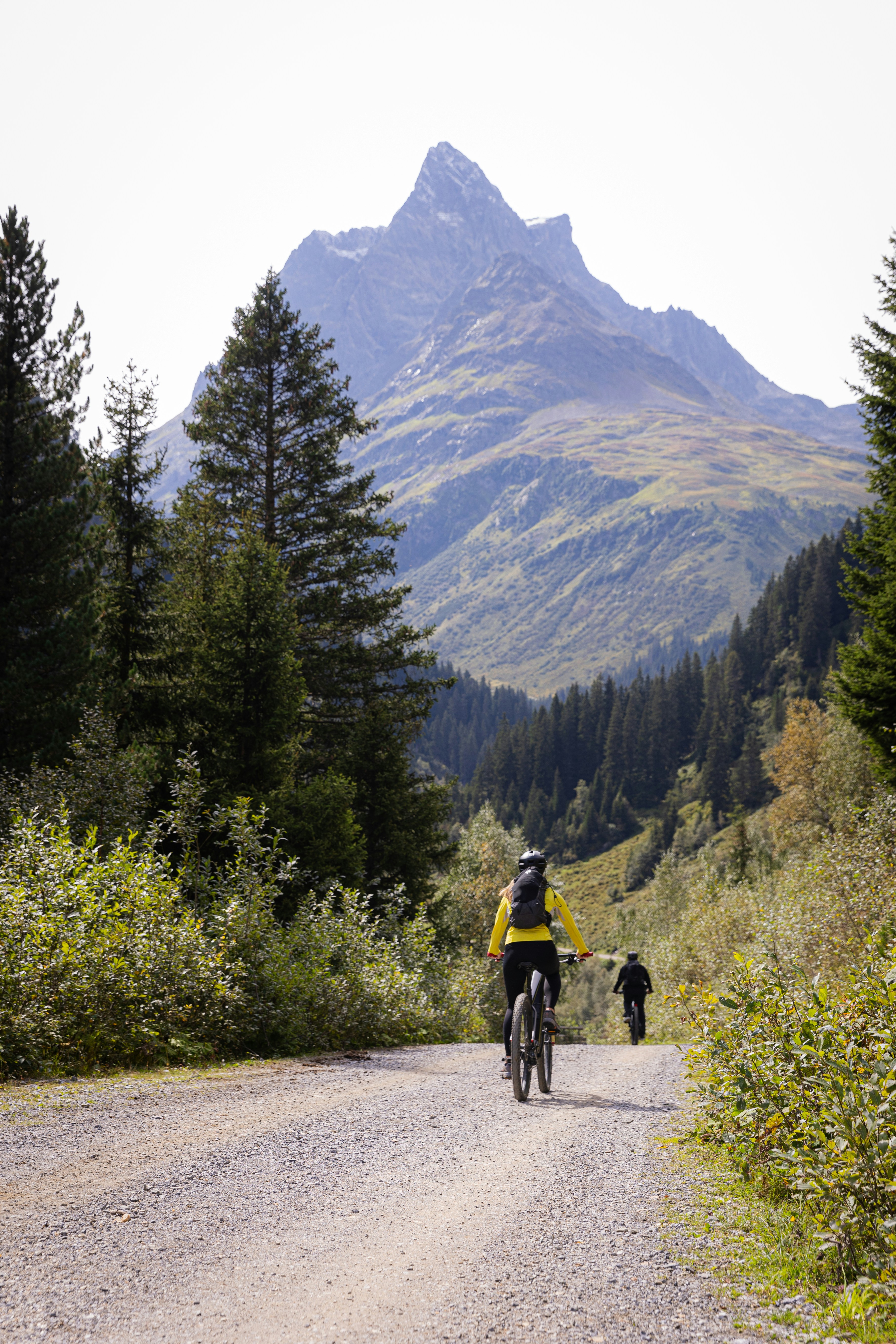 A man riding a bike down a dirt road