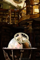 A room filled with lots of books and a ceiling fan