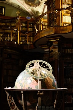A room filled with lots of books and a ceiling fan